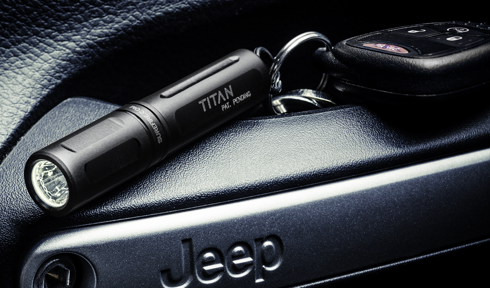 SureFire Titan keychain flashlight on Jeep dashboard